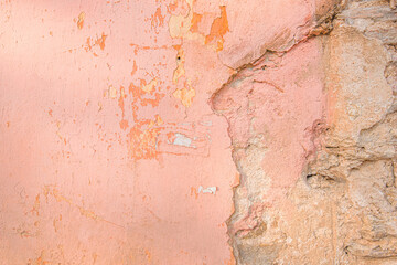 Distressed pink old brick wall. Background with painted peeling plaster. Abstract grunge wall. Abstract plastered wall web banner. Design element.