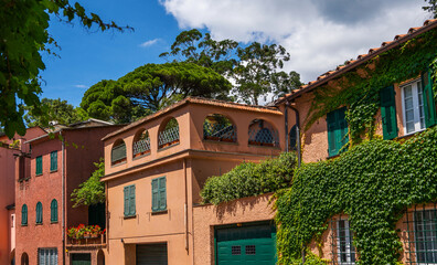 Eco architecture with plants and flowers on the facade. Ecology and green environment concept. Colorful mediterranean buildings in spectacular resort, Liguria, Italy, Europe. 