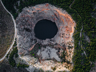 Aerial drone picture of massive crater, blue hole (red lake) in April at Imotski, Dalmatia, Croatia