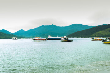 Boats on the beach with mountains in the background