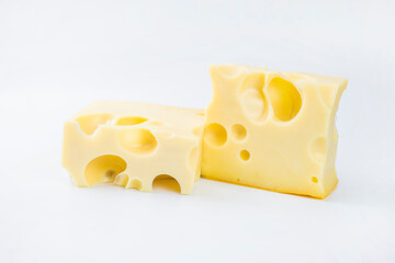 a piece of cheese with big holes Maasdamer on a light background