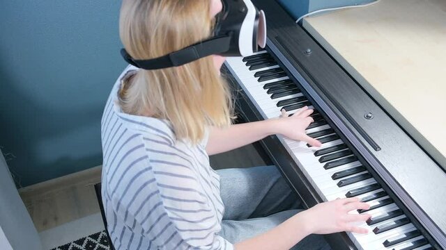 Virtual reality. The girl studies the game on the phono with glasses VR. metaverse, digital world, immersive project. The virtual world VR , interactive at home.Metaverse home,Immersive experience