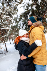 Fototapeta na wymiar Photo of charming pretty marriage couple wear windbreakers embracing smiling having fun walking snowy weather outside park 