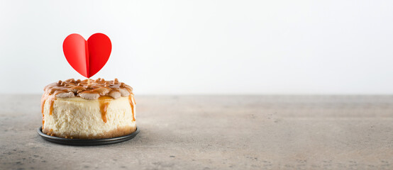 Small bento cheesecake decorated with small hearts topper. Valentine's day concept. Banner image