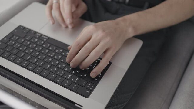 Laptop keyboard. Action. A person sits at a computer and works in modern conditions, close shooting of the keyboard and the printing process.