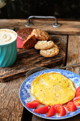 breakfast. fried eggs with tomato, coffee and cookies.