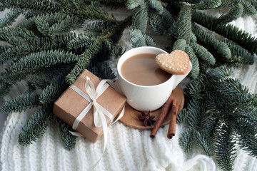a cup of cocoa, cookies, a gift box and spruce branches. congratulations on valentine's day, march 8, gift to mom, romantic background.
