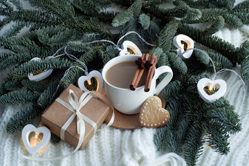 fir branches, a cup of coffee, cookies, gift box. congratulations on valentine's day, march 8, gift to mom, romantic background.