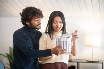 Man giving gift box to surprised woman