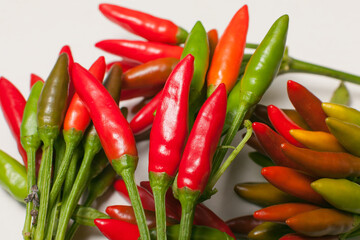 many small chili peppers on white background