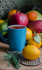 Fruits bergamot, pomegranate, lemon, pamelo, pear, tangerine, mango on a wooden background.