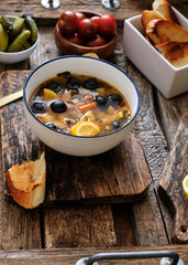 Solyanka soup. Soup with meat, salami, olives, lemon. Side view. 