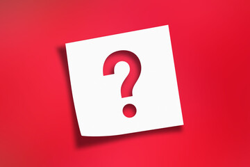 Note paper with question mark on red background	