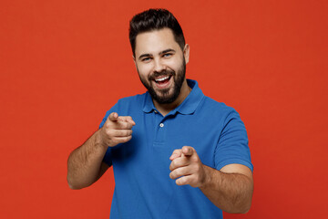Young smiling happy caucasian man 20s wear basic blue t-shirt looking camera point index finger...