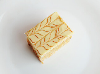 Slice of traditional Hungarian and Austrian Esterhazy cake on white background