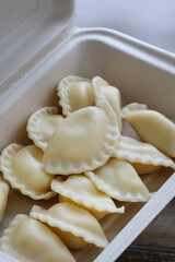 Dumplings in recyclable paper box.