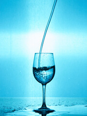 splash of water in a wine glass