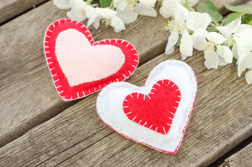 Valentines day card, two hearts on wooden background with apple tree flowers