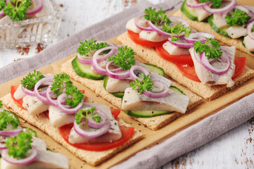 Sandwiches with herring and vegetables