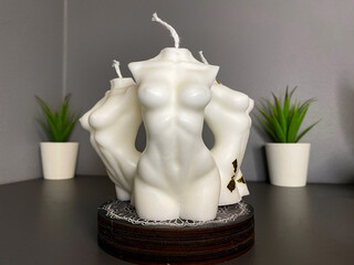 three trendy soy candle female bodies on the grey table