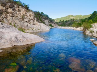 Big deep pool for swimming in river Solenzara at the foot of Bavella peaks in Southern Corsica, France.