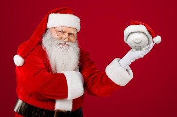 Santa Claus Christmas piggy bank money box. Festive saving concept