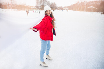 Happy smile woman in winter with skates on outdoors ice rink sunset