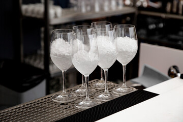 Glasses for white wine with ice at the bar at the buffet table presentation event