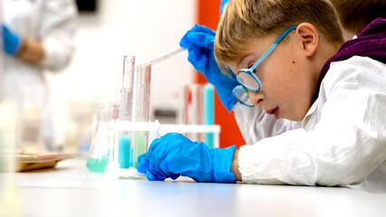 Moscow, Russia, November 21, 2021. Children perform chemical experiments with a white liquid