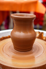 Fototapeta na wymiar A jug made of brown clay just made by a pottery master. Folk art.