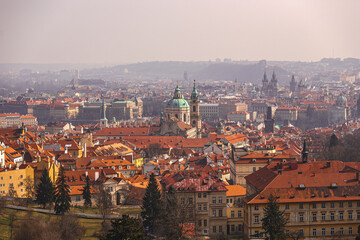View of the city of Prague in the morning haze from the hill.
