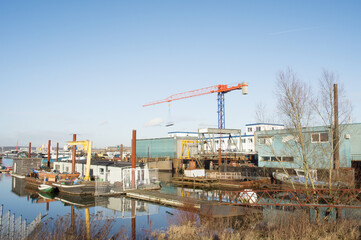 Shipyard with large orange and blue crane in Arnhem in the Netherlands