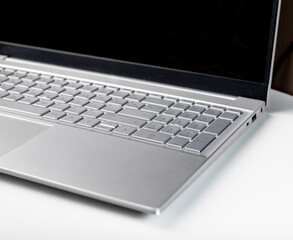 Laptop keyboard and screen closeup. Silver keypad details.