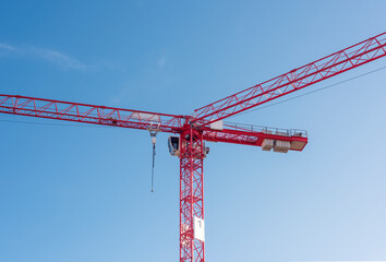 two red cranes against blue sky