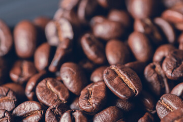 Fresh roasted coffee beans background, Dark tone, Selective focus.