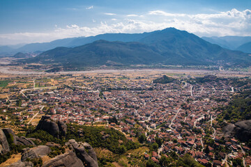 Beautiful scenic view of the small Kalabaka town on top of the cliff, from Holy Trinity Monastery (Agia Trias), trough Meteora rock formations, Greece.