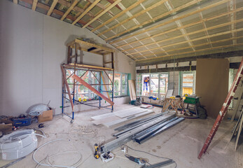 Working process of renovate room with installing drywall  with construction materials are in...