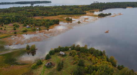 Russian village with wooden old houses on an island in Lake Onega, in autumn in Karelia Russia