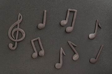 Treble clef and music notes on black background. Music symbol. Key of G. Violin key. Musical...
