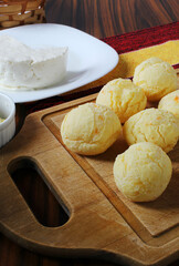 Cheese balls. Brazilian cheese bread with white cheese in the background.