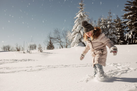 Little child playing with snow