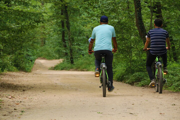chosen focus. People cycling on the wonderful forest road among the trees in Izmit Ormanya.	
