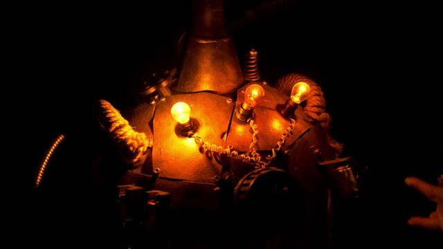 Steampunk. Female hand turns on the light bulbs on the dewar Vessel close-up. Dark