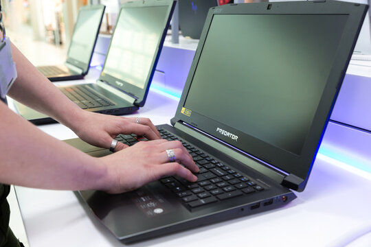 Acer Predator Laptop Computer Displayed In Electronic Store, Close Up Of Woman Hands.