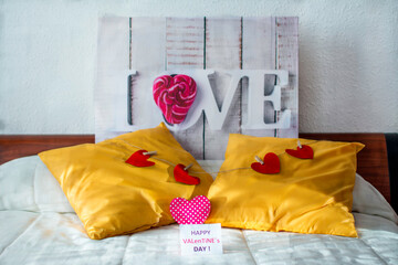 Valentine day greeting concept in bedroom with romantic, love, decoration with hearts and postcard.