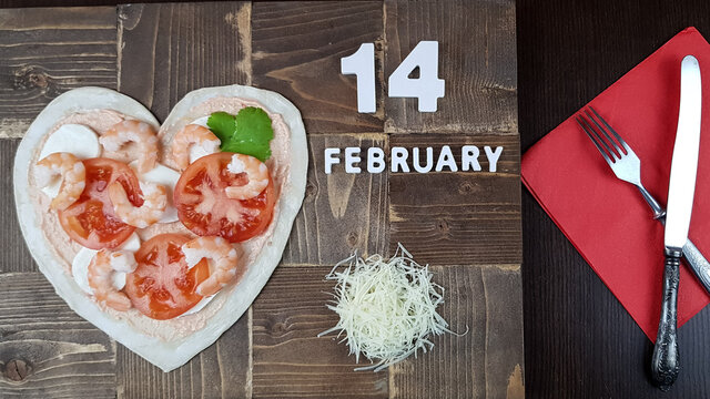 the image of a pizza in the form of a heart. preparing for a Valentine's Day dinner. intimate dinner for lovers