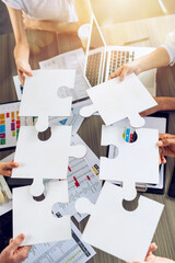 Teamwork of partners connect puzzle pieces as integration and startup