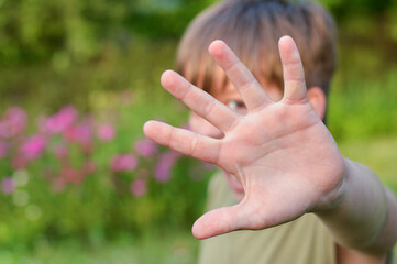 Blurred image of a boy defending himself with his hand.Child abuse, domestic violence.