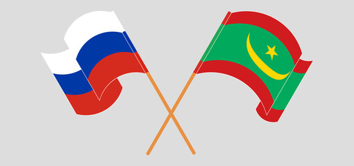 Crossed and waving flags of Russia and Mauritania