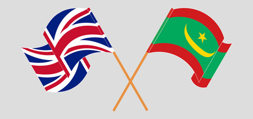 Crossed and waving flags of United Kingdom and Mauritania